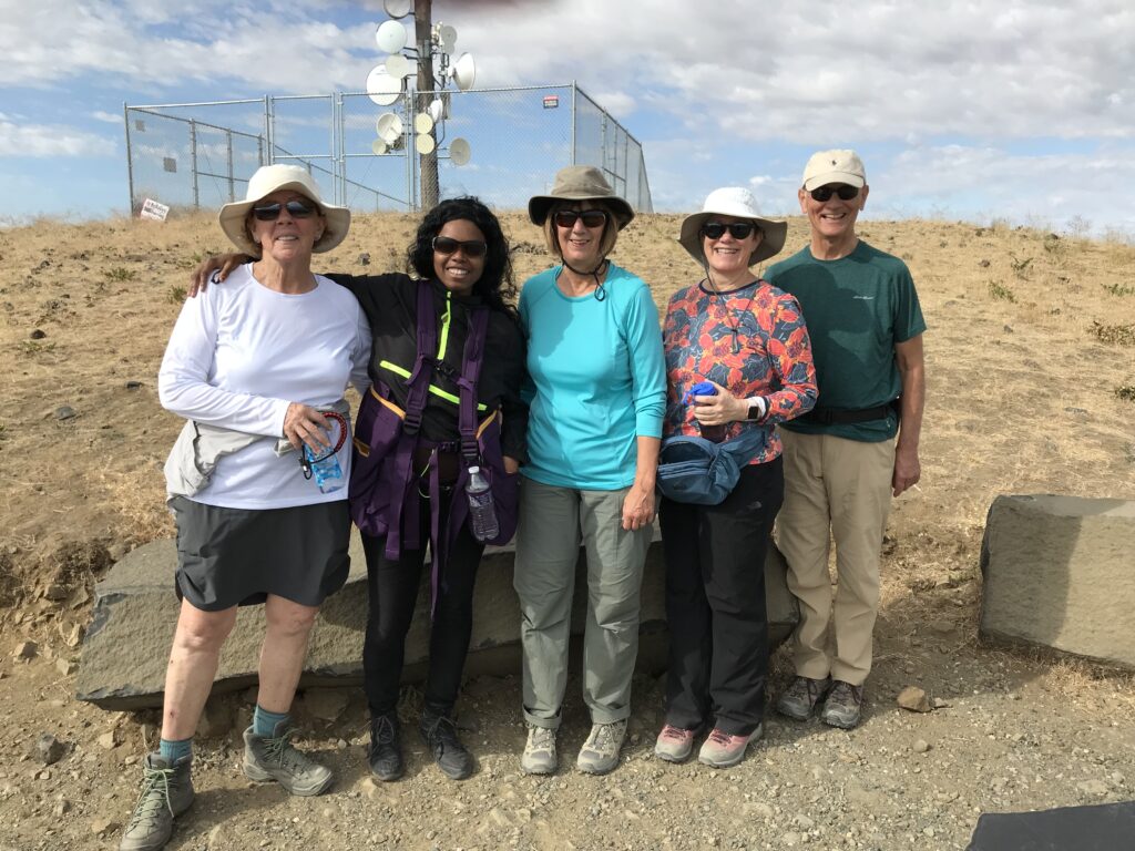 The blind hiker poses with other hikers at the top of Candy Mountain.