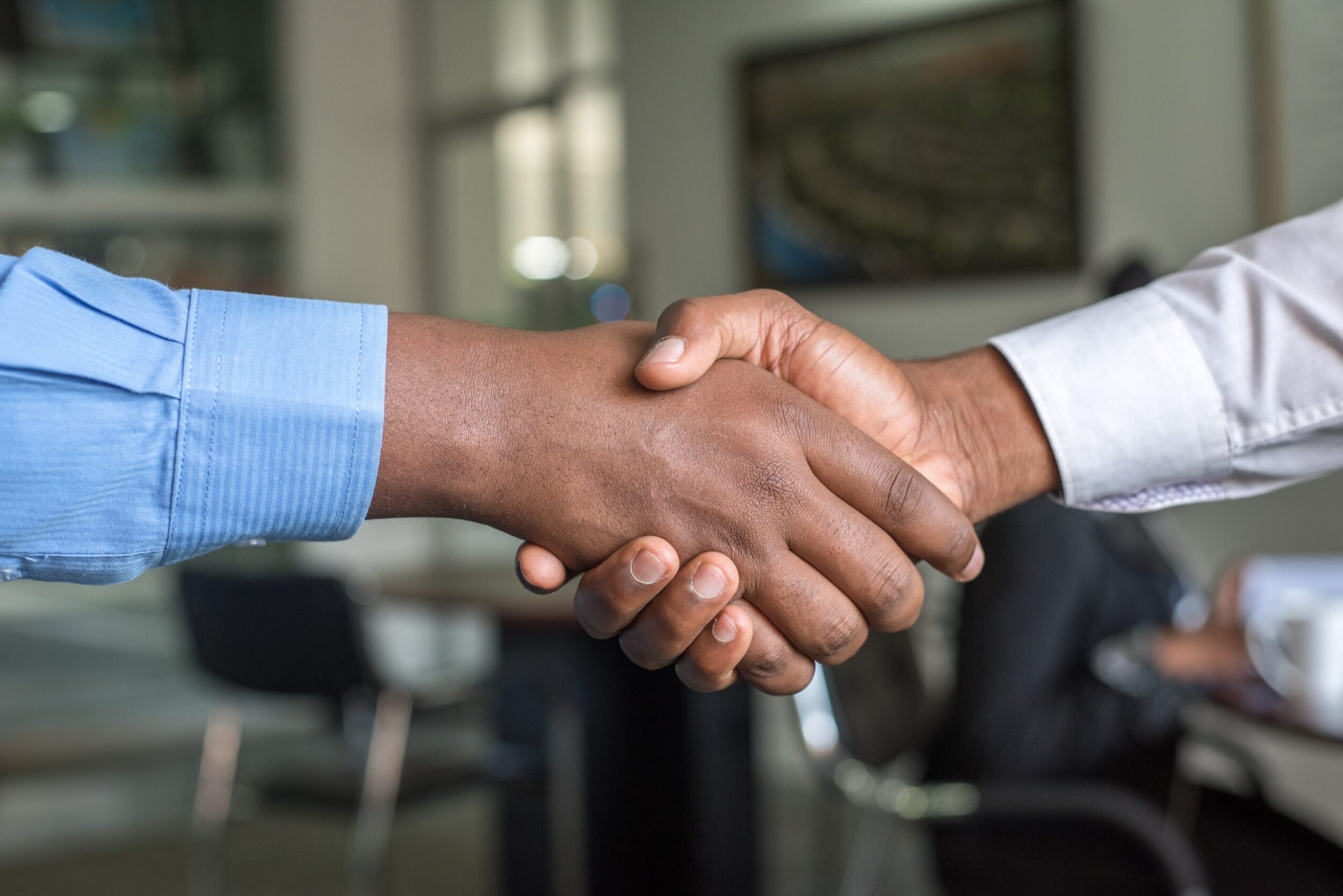 Two Black people shaking hands. Photo by Cytonn Photography on Unsplash